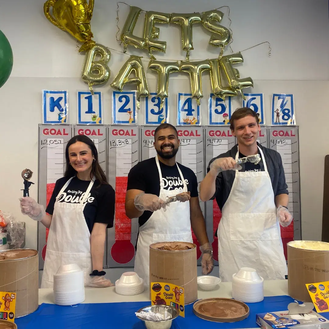 Fundraising volunteers serve ice cream as incentives for fundraising, celebrating students’ progress toward their school goals.