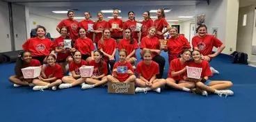Rochambeau Rebels posting with Double Good popcorn after their successful cheer fundraiser.