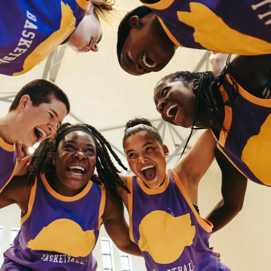 Group of young adults gathering together for their basketball game