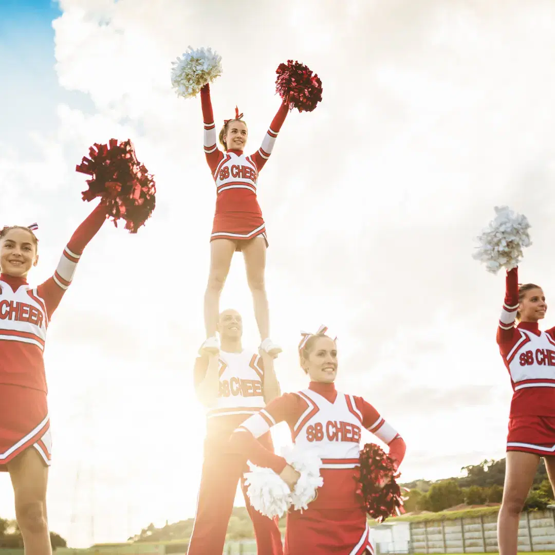 Cheerleading team cheering together