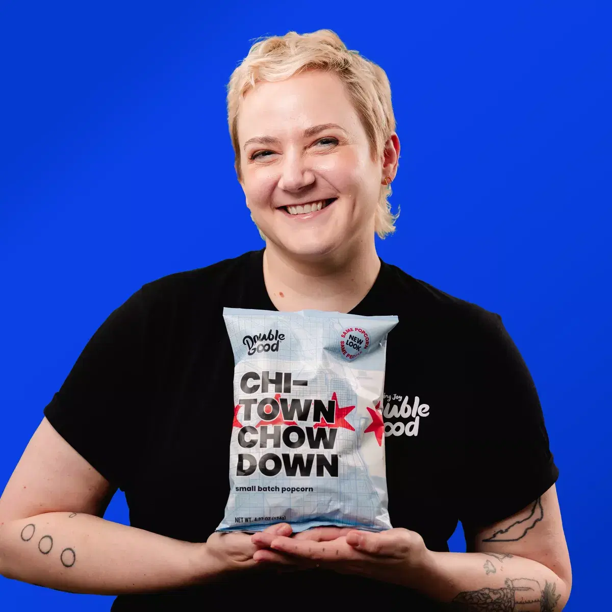 A picture of Amy holding a bag of popcorn and smiling.